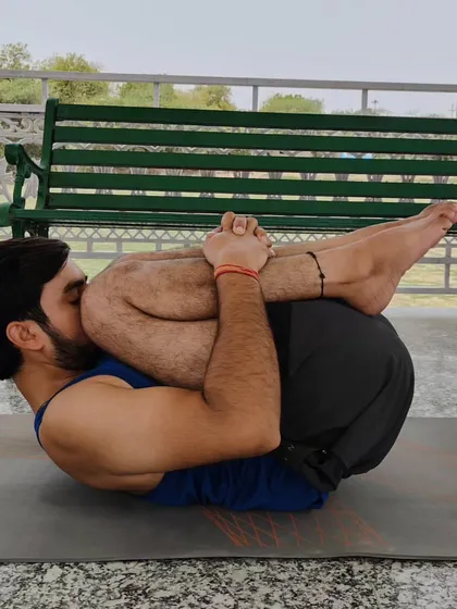 This is Pawanmuktasana, a pose that is excellent for improving digestion and providing instant relief from gastric issues. It also gently stretches the neck and back, helping to reduce stress.