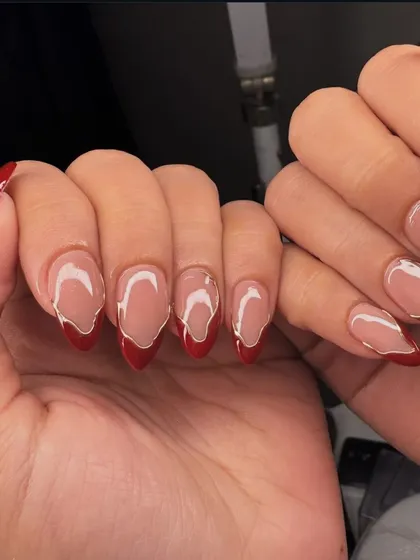 A cool, abstract take on a French manicure with a wavy red tip.