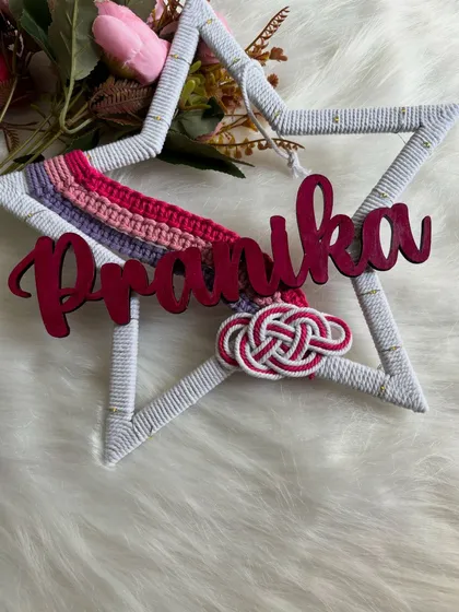 A star-shaped name hanging for Pranika, featuring a mini rainbow and a Celtic knot detail. This design is perfect for adding a touch of magic and personalization to a nursery or bedroom wall.