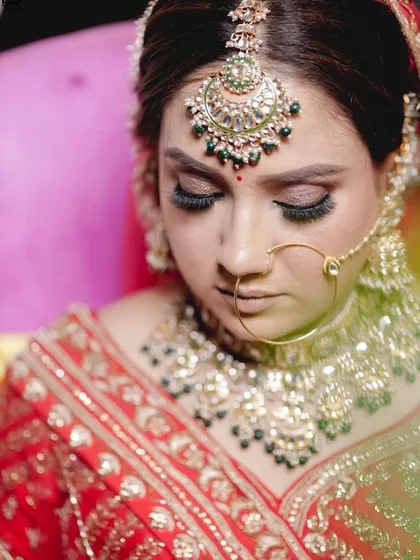 A close-up shot focusing on the bride's stunning makeup and jewelry.