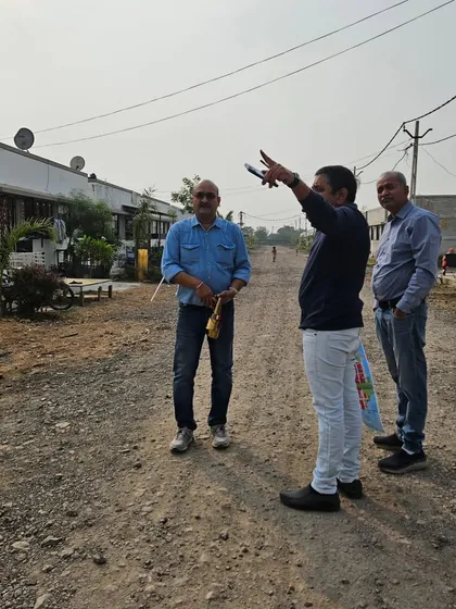 On-site at a rural development project, guiding the team on the layout of new homes according to Vastu principles for community well-being.