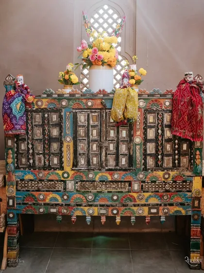 A stunningly intricate, hand-painted cabinet adorned with traditional Rajasthani puppets ('kathputli'). This piece served as a unique decor element that celebrated local art and craft.