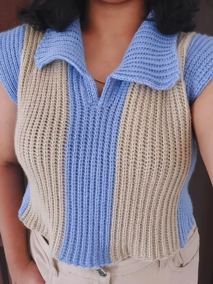 A close-up view of the Knit-Like Sweater Vest, highlighting the vertical stripes and polo collar.