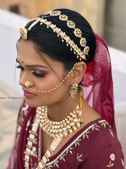This side profile highlights the beautiful Rajasthani matha patti and the soft smokey eye makeup. I ensure every detail, from hair to makeup, aligns with the bride's cultural traditions.