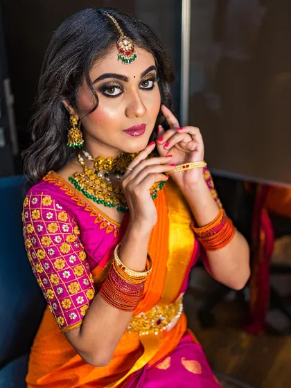 A close-up of this stunning South Indian look. I created a bold, gold and black smokey eye that brings all the drama, balanced with a soft lip color. You can also see the intricate details of the traditional temple jewelry and how the makeup complements it perfectly.