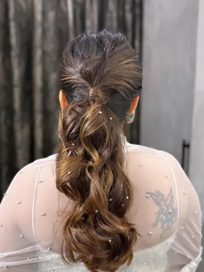 The back view of the pearl-accented messy ponytail, showing the beautiful texture and detail.