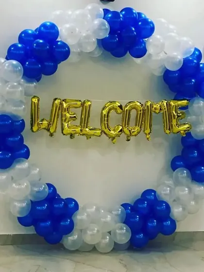 A simple and clean "Welcome" ring in blue and white balloons with gold foil letters.