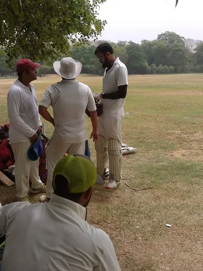 Players discussing strategy on the sidelines during a match. Game awareness and tactical thinking are key components of our coaching philosophy.