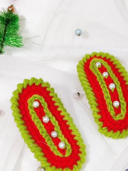 Festive Christmas-themed hairclips in red and green with pearl accents.