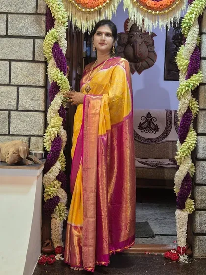 Our client Vedha looks stunning in this yellow Bandhani silk saree with a rich pink and gold border.