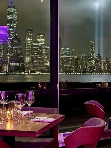 A table with a view at LokalJC, looking out at the iconic Tribute in Light in Manhattan. Our design prioritizes the connection to the location, ensuring the view is always the star.