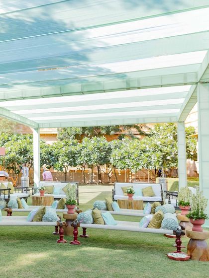 Low seating arrangements with mint green and yellow cushions provided a comfortable and casual space for guests at this sunny Haldi. The striped canopy offered shade while adding to the relaxed, garden-party vibe.