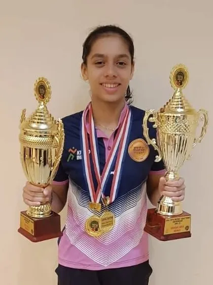 Ananya Chande with her double crown trophies from the JVPG district tournament. Winning both the U-17 and Women's categories is an incredible display of skill and stamina.