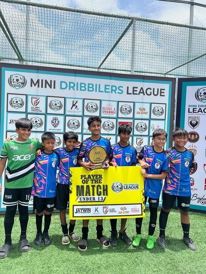 Our U13 team celebrating with their 'Player of the Match' award after a successful game.