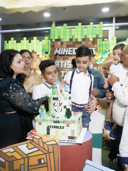 A happy moment from a Minecraft-themed birthday party. We create immersive worlds for kids, complete with themed cakes, pixelated backdrops, and character props that make the celebration special.