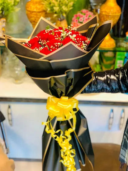 Another angle of the elegant red rose bouquet, showcasing the sharp lines of the Korean-style black wrapping.