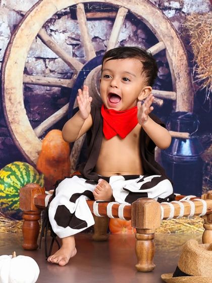 A joyful shout from our little cowboy. His energetic and happy expression is the highlight of this fun, farm-themed photoshoot.