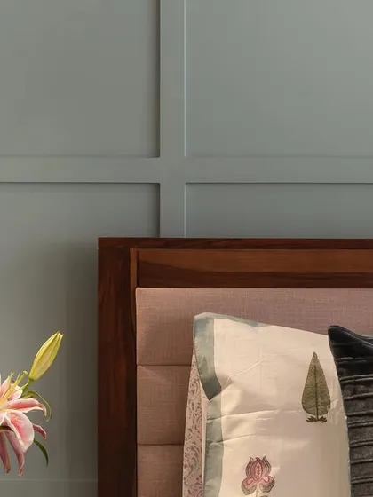 A detail shot of the master bed, highlighting the adjustable reading light against the paneled wall. Small details like this enhance both the functionality and aesthetic of the space.