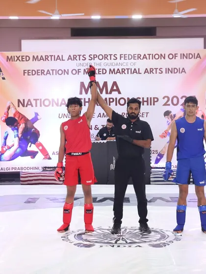 A decisive moment at the FMAAI National Championship in Mumbai, with our fighter's hand being raised in victory after a tough bout.