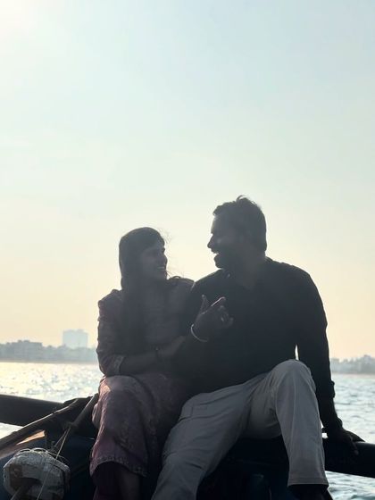 A beautiful silhouette shot of a couple enjoying the sunset during their romantic boat ride.
