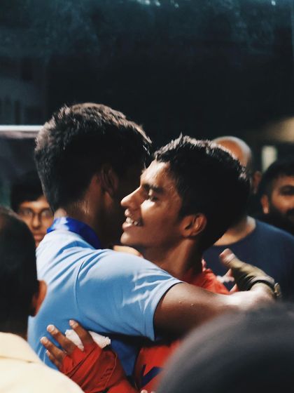 Sportsmanship is everything. Two fighters embrace after their match, showing respect for each other regardless of the outcome. Win or learn.