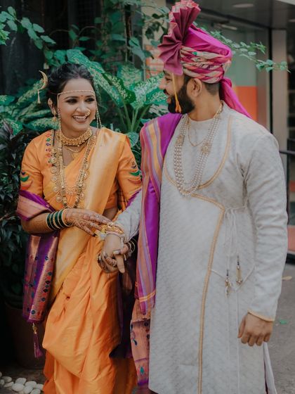 Walking into their new life together. This candid shot captures the couple sharing a glance and a smile as they walk hand-in-hand.