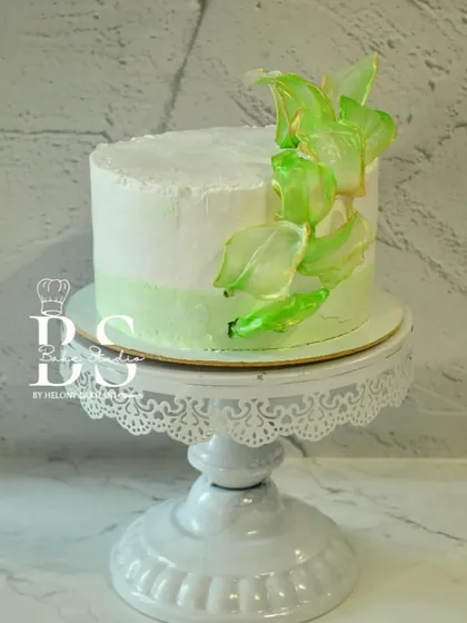 A beautiful whipped cream cake with a soft green ombre and delicate, translucent green sugar sails, created during Week 1 of my masterclass where we focus on mastering whipped cream.