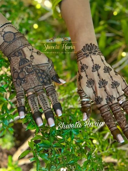 A creative back-hand design with a different theme on each hand: one features a peacock and doli, while the other has a delicate lotus pattern.