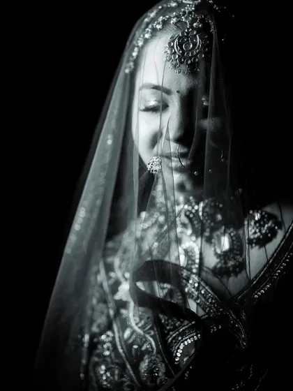 A delicate black and white portrait of the bride under her veil.