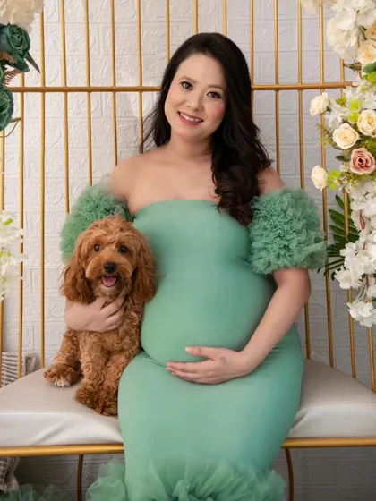 Your fur babies are family too. I welcome well-behaved pets into my studio to be part of your maternity session. This portrait captures the sweet connection between the mother-to-be and her furry friend, adding another layer of warmth to their growing family's story.