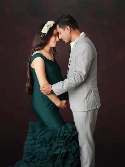 A colorful alternative to the classic pose. This couple portrait captures the same intimacy and connection, but with the vibrant green of the gown adding a layer of richness.