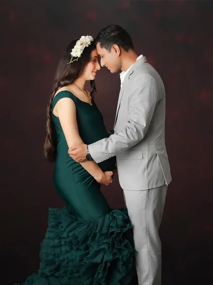 A colorful alternative to the classic pose. This couple portrait captures the same intimacy and connection, but with the vibrant green of the gown adding a layer of richness.