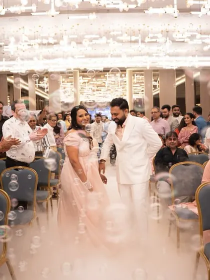 Another shot of the couple's grand entrance, surrounded by family, bubbles, and a magical cloud of fog. It’s a moment straight out of a fairytale.