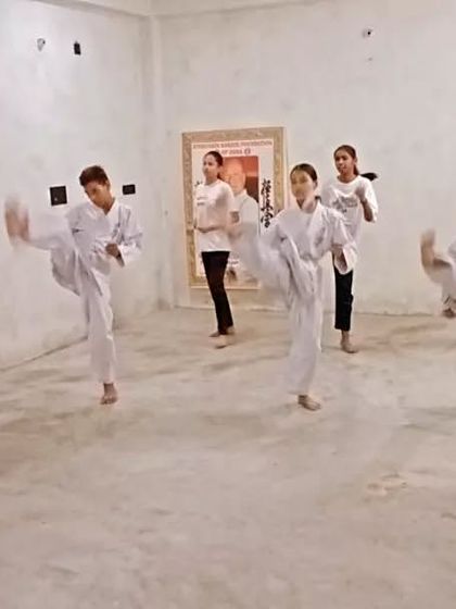 A student executes a front kick (mae geri). We aim for the solar plexus or head, depending on the situation.