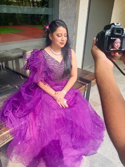 A behind-the-scenes shot of a photoshoot. The makeup is designed to be camera-ready, looking flawless under professional lighting.