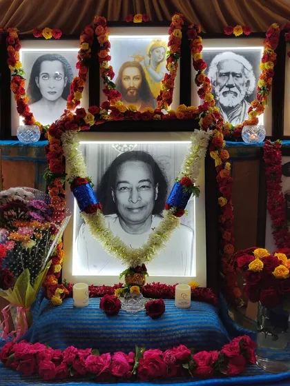 A close-up of our altar, lovingly decorated for a Sunday Satsang. The portraits of our line of Gurus, from Paramhansa Yogananda to Jesus Christ, are adorned with fresh flowers, representing our devotion and gratitude for the light they bring into our lives.