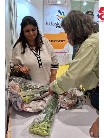 Our director, Seema Jhaveri, and instructor, Harinakshi Mistry, inspect the fresh flowers before the IndiaSkills competition begins, ensuring quality for all participants.