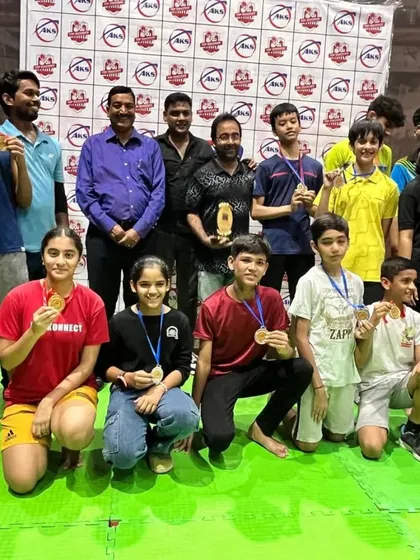 The AKS family celebrating together after a successful tournament. Seeing my players with their medals and trophies is the result of all the hard work we put in on the court.
