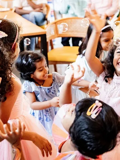 Birthday parties are about more than just cake. They are about the joy, the friends, and the pure excitement. This shot of children playing and laughing together captures the vibrant, energetic atmosphere of a kids' birthday party.