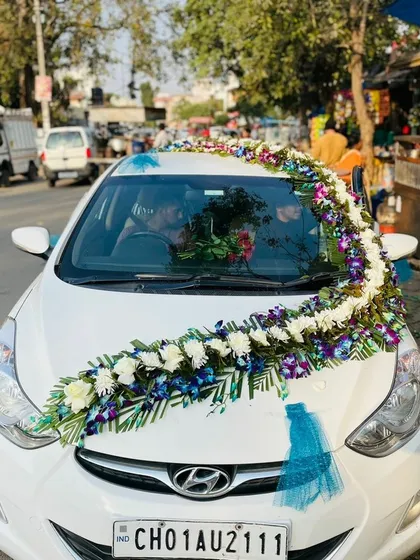 This shows the complete look of the blue orchid flower decoration on the wedding car, done on-location for your convenience.