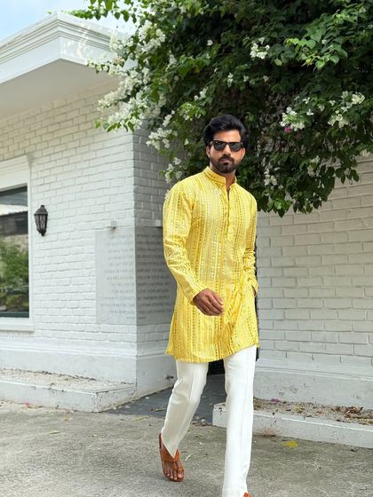 The modern gentleman's choice for festive wear. This yellow kurta combines traditional patterns with a contemporary fit, creating a look that is both culturally rooted and fashion-forward.