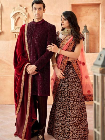 Royal elegance in deep velvet. This groom's sherwani in rich maroon is paired with a luxurious velvet shawl, creating a look of unmatched opulence and warmth for a winter wedding.