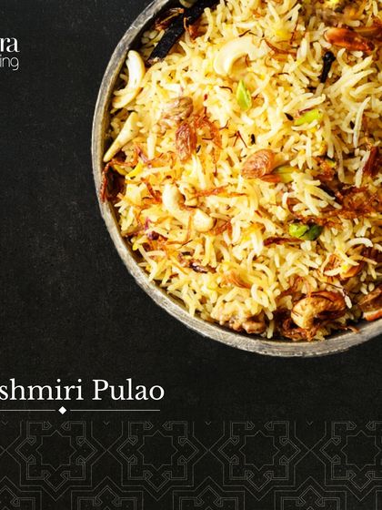 A bowl of aromatic Kashmiri Pulao. This North Indian rice dish is cooked with saffron, nuts, and fruits, offering a rich and mildly sweet flavour.