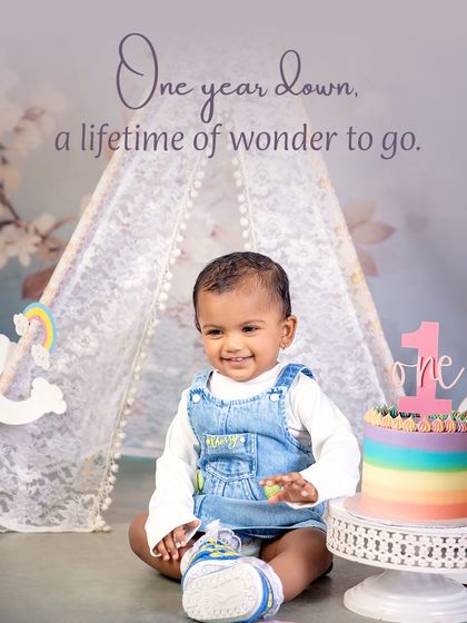 One year down, a lifetime of wonder to go. A beautiful portrait from a first birthday session, complete with a rainbow cake and a happy smile.