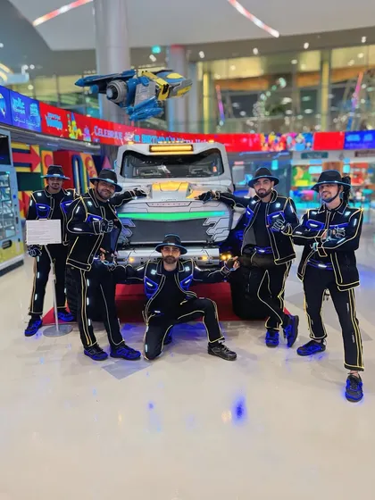 Posing with a futuristic vehicle at an event in Doha. Our costumes fit right in with the high-tech atmosphere of the city.