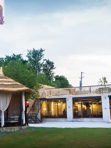 A daytime view showing one of our bamboo cabanas situated on the lawn next to the main cafe building. It offers a private outdoor experience with easy access to all amenities.
