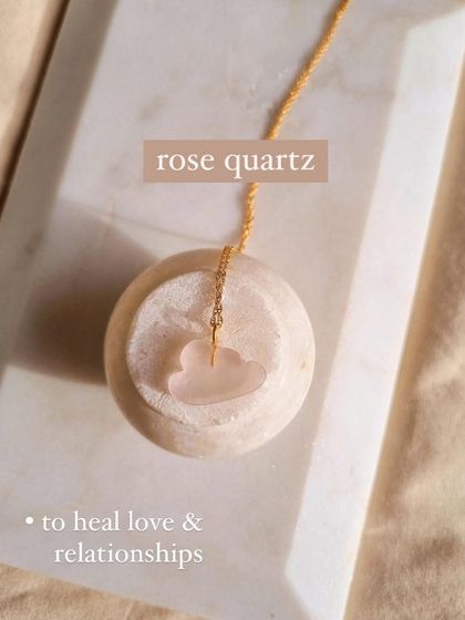 This is my 'Barbie's cloud' pendant, carved from Rose Quartz. I designed this dreamy piece to help heal love and relationships, carrying the stone's gentle energy in a playful shape.
