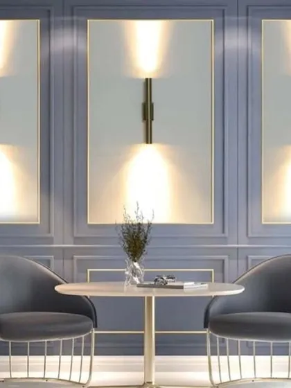 A cylindrical wall lamp in a golden finish, this fixture provides both up and down lighting. The sleek, minimalist design is perfect for creating a sophisticated and modern ambiance in a living room or dining area.