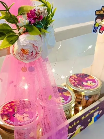 A detailed shot of the floral decoration and custom-labeled jars in the Rakhi basket.