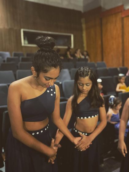 A quiet moment of focus and prayer between two dancers before they go on stage. The bond between our students is truly special.